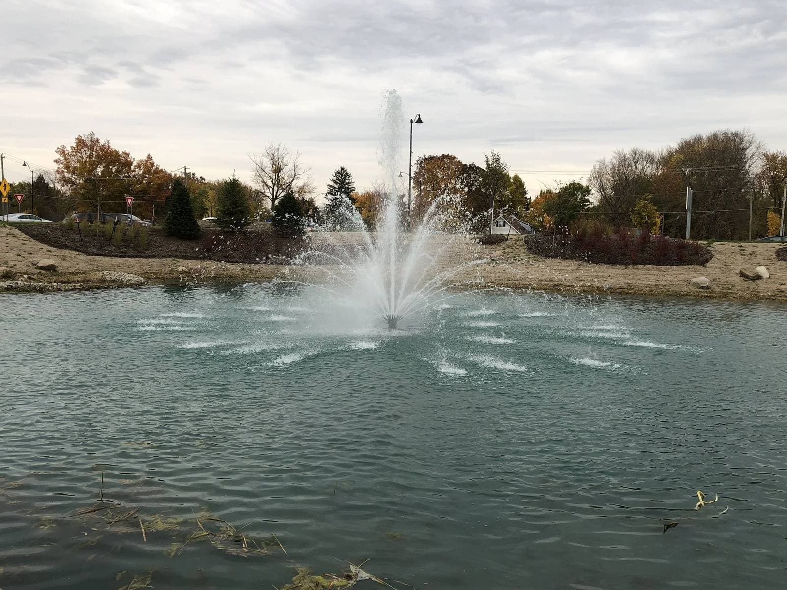 Fountain spray on a community pond in autumn
